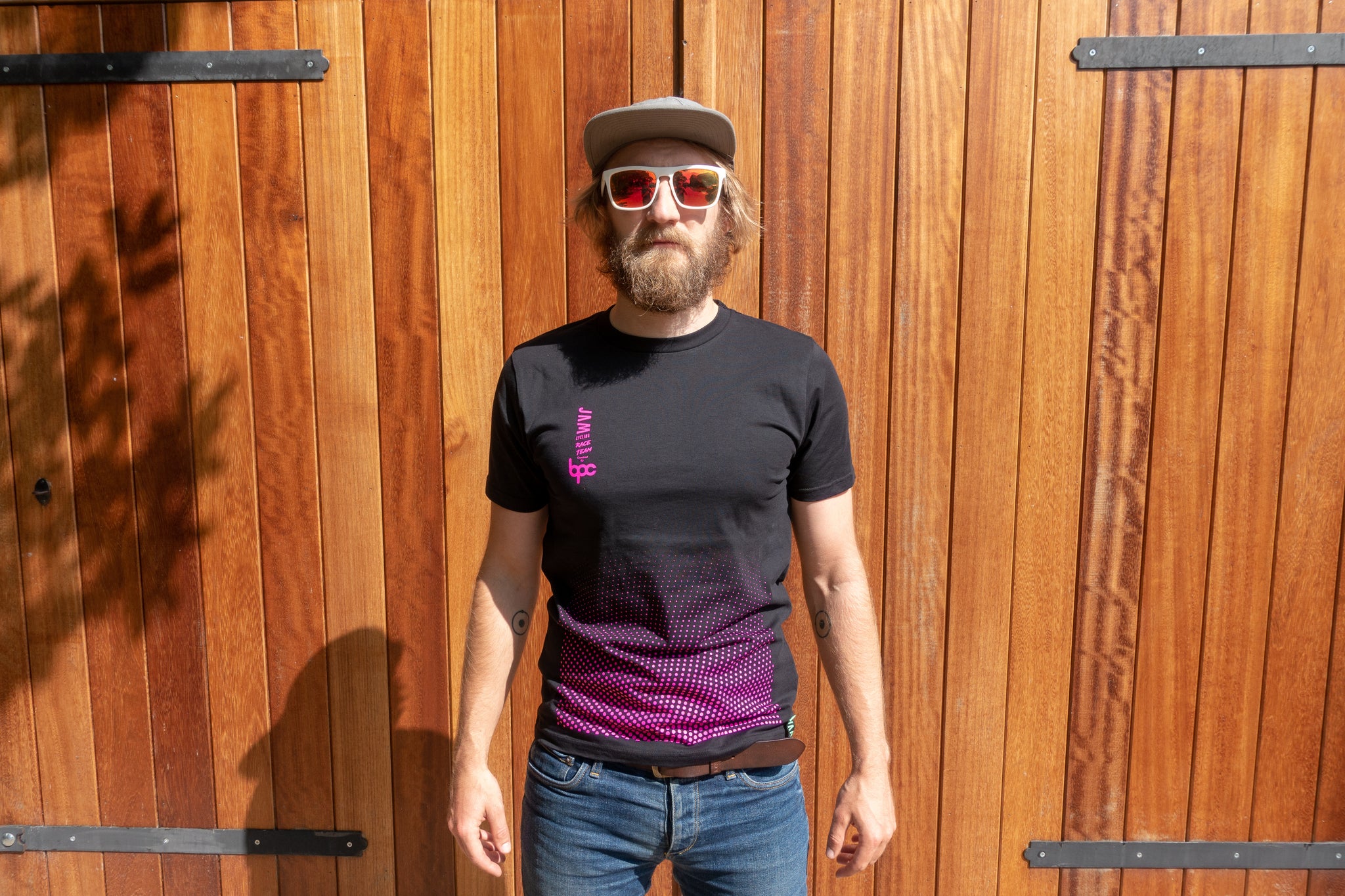 JAM Race team t-shirt featuring HOT pink dotted pattern worn by Jam CEO  against barn door