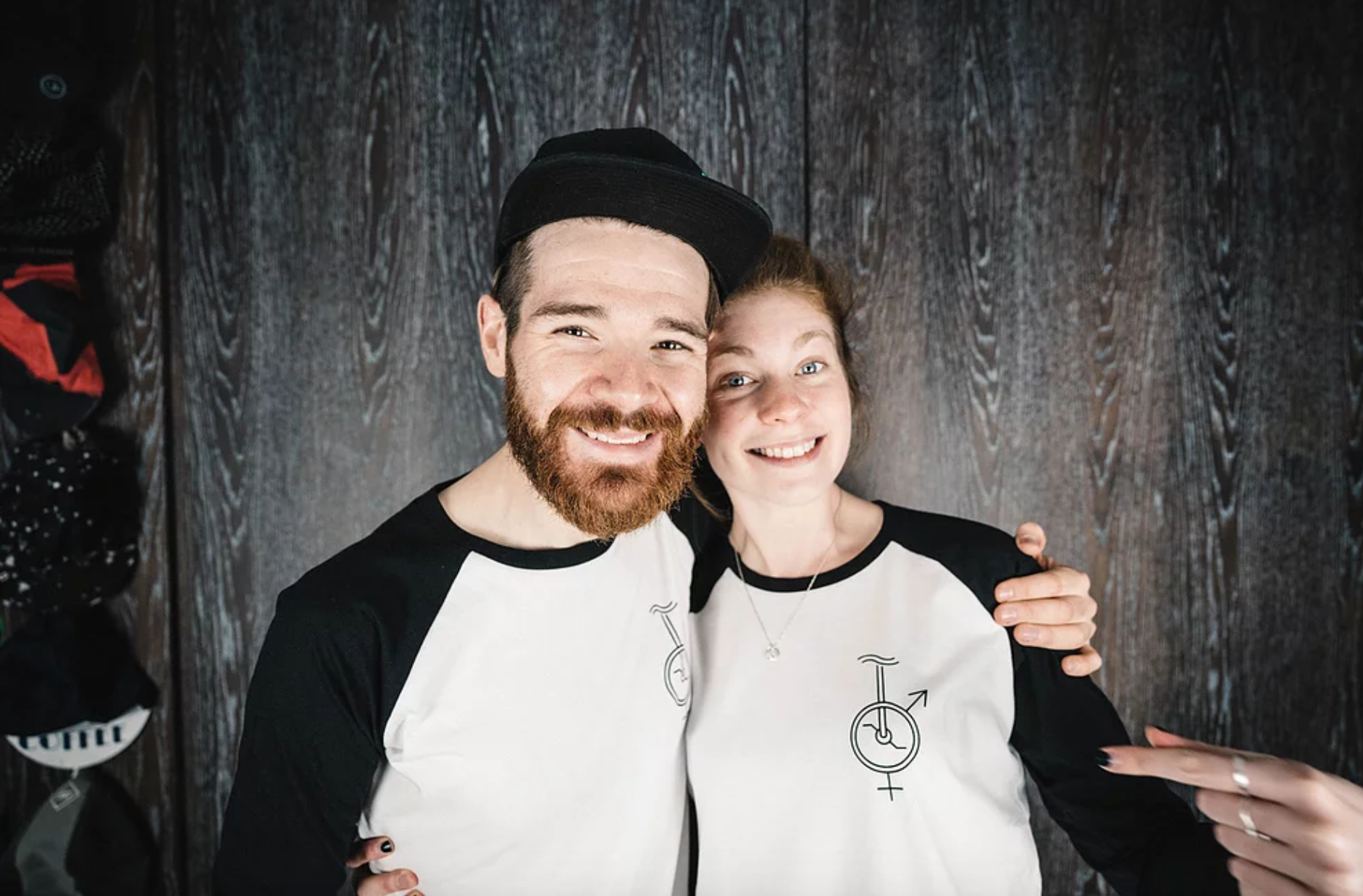Unicycle black and white baseball t-shirt worn by two happy JAM employees