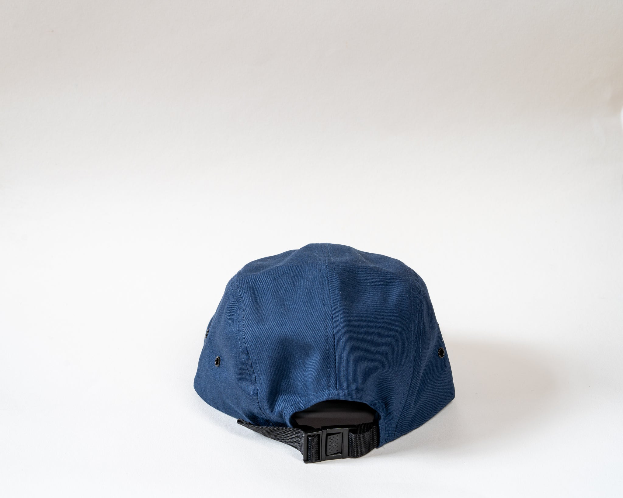 Navy 5 panel cap showcasing the rear clasp on a white background