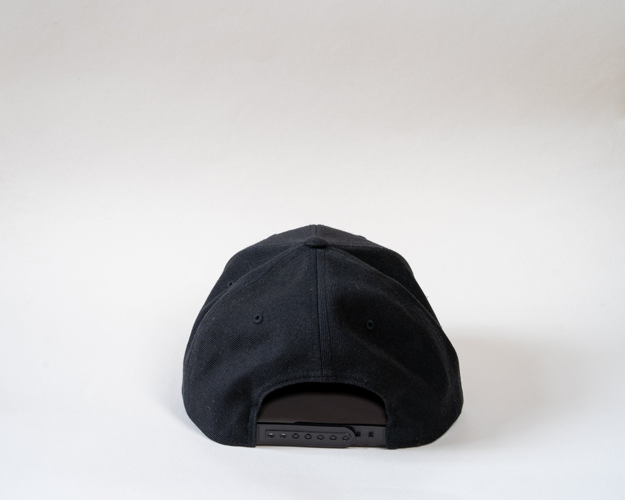 Jam Snapback cap showcasing rear clasp sitting on a white background
