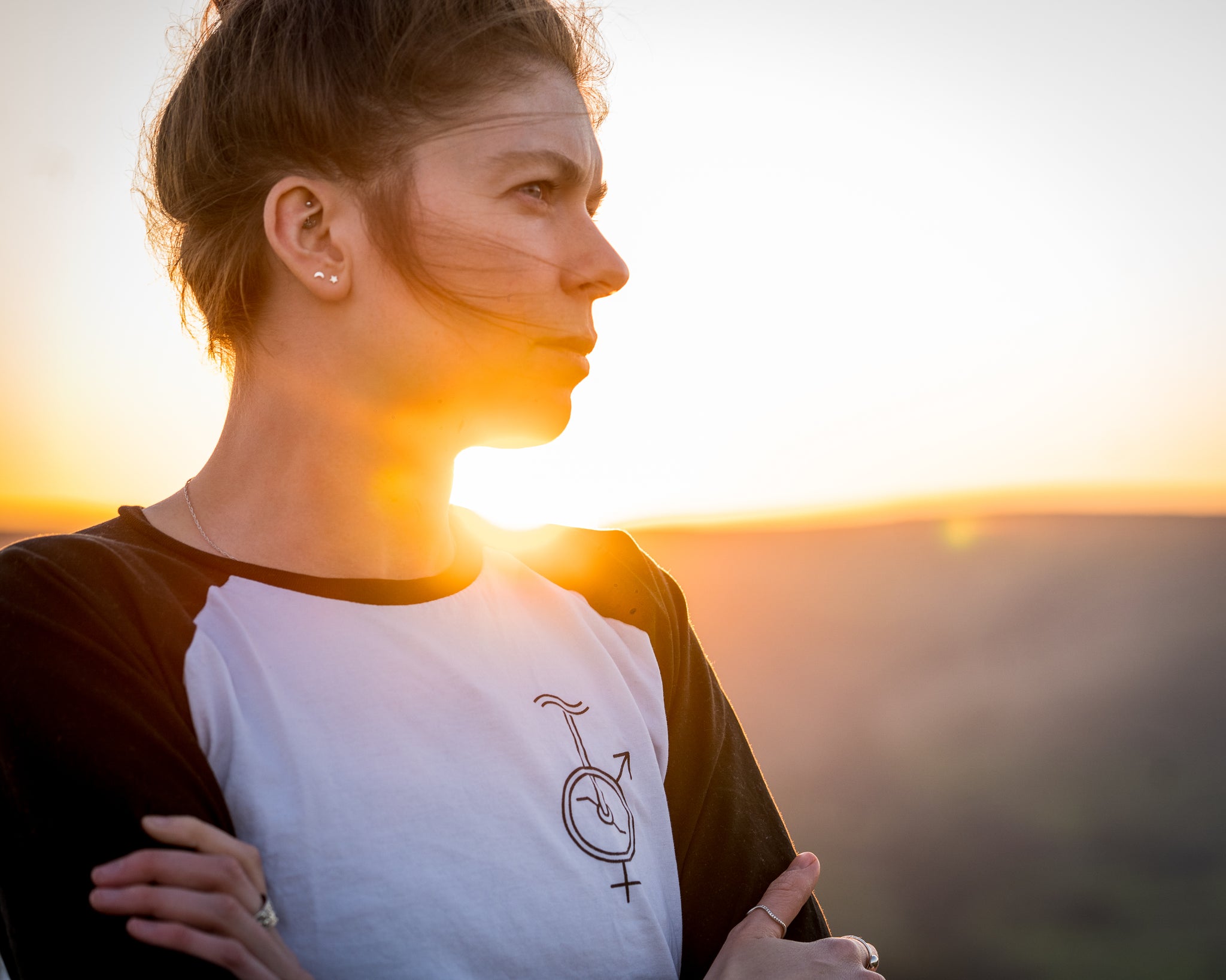 Unicycle baseball t-shirt sunset picture female employee looking powerful into the distance